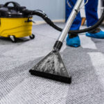 Photo Of Janitor Cleaning Carpet With Vacuum Cleaner